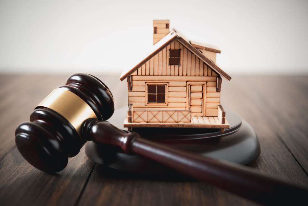 A house and gavel to represent real estate law attorneys lawyers